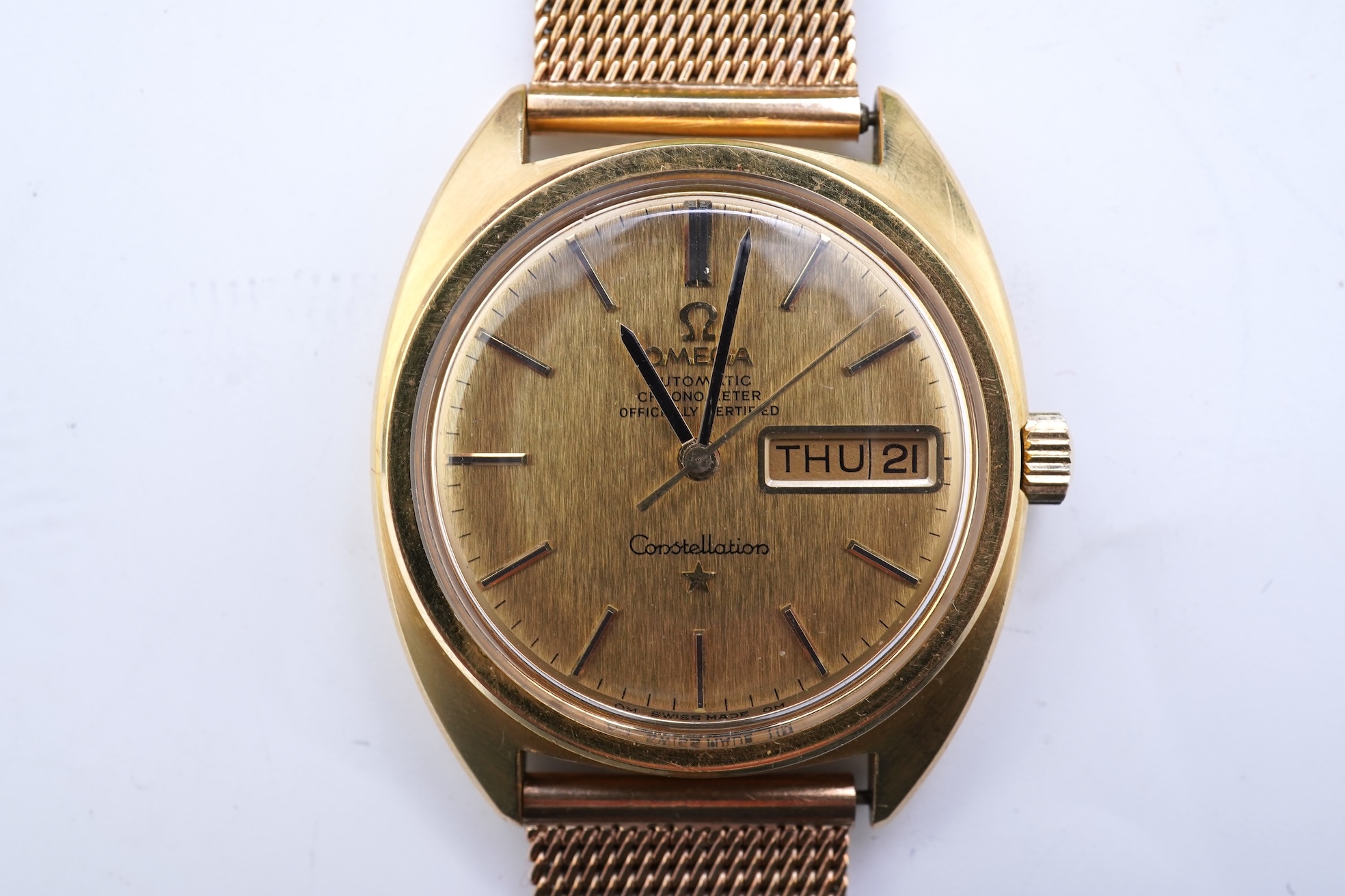 A gentleman's late 1960's 18ct gold Omega Constellation Automatic Chronometer Officially Certified wrist watch, on an associated 9ct gold mesh link bracelet